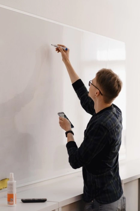 An employ of Techoboll writing some thing on white board